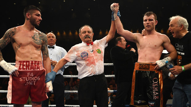 The Reckoning: Jeff Horn (right) is declared winner of the middleweight boxing clash against Michael Zerafa (left) at the Brisbane Convention and Exhibition Centre.