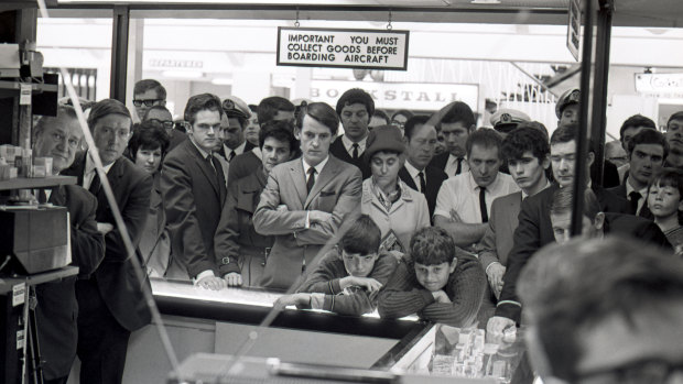 Crowds gather around a television set at Sydney Airport to watch the broadcast of American astronaut Neil Armstrong becoming the first man to walk on the moon, July 21, 1969.