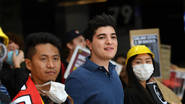 Drew Pavlou (centre) at a protest outside the Chinese consulate in Brisbane the day the University of Queensland said he would be suspended for two years.