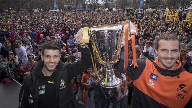 Richmond's Trent Cotchin and GWS captain Phil Davis pose with the premiership cup on grand final eve.