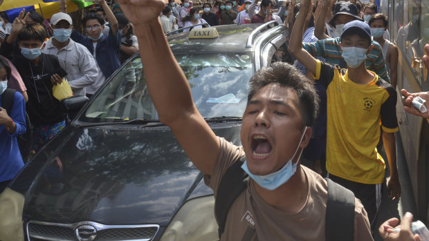 Anti-coup protesters shout slogans during a flash-mob demonstration earlier this month in Yangon, Myanmar.