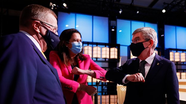 The president of the International Olympic Committee, Thomas Bach, right, bumps elbows with Premier Annastacia Palaszczuk and John Coates. 