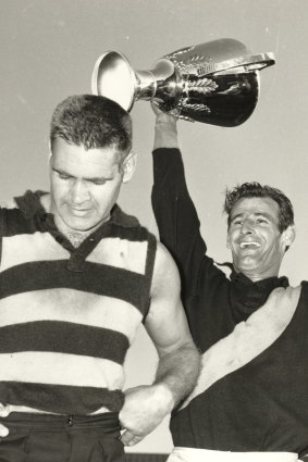 Polly Farmer and Richmond captain Fred Swift holding aloft the 1967 VFL grand final cup. 