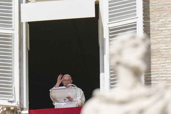 Pope Francis waves during the noon prayer from the window of his studio overlooking St Peter’s Square on Sunday. 