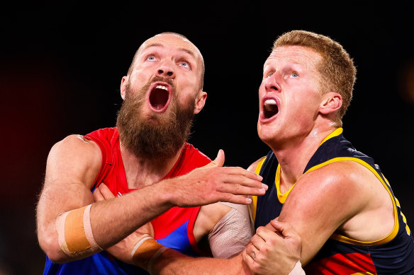Max Gawn, left, pictured in action against Adelaide's Reilly O'Brien, right, has been sidelined with knee and back soreness. 