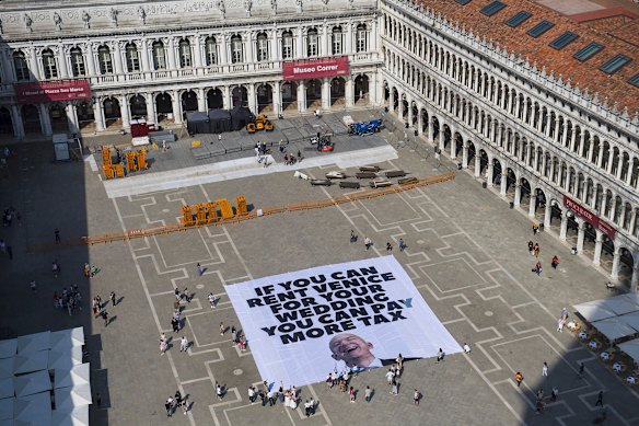 This photo released by Greenpeace shows a large banner against Amazon founder Jeff Bezos’ planned wedding, at Piazza San Marco, Venice. The wedding has since been moved.