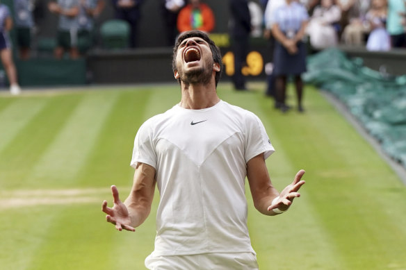 Carlos Alcaraz celebrates after his five-set win over Novak Djokovic at Wimbledon.