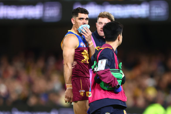 Charlie Cameron leaves the field  after losing two teeth against Richmond.