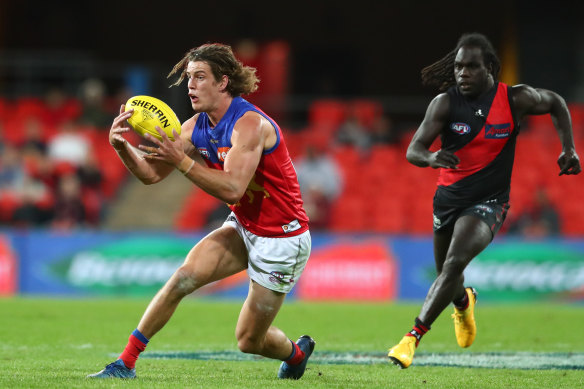 The Lions' Jarrod Berry steams clear of Bomber Anthony McDonald-Tipungwuti.