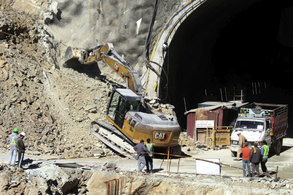 Heavy machinery works at the entrance to the tunnel.