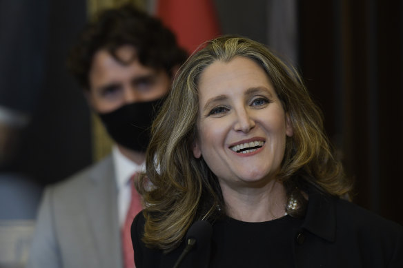 Prime Minister Justin Trudeau looks on as Chrystia Freeland speaks to the media after her new appointment. She is the first woman to hold the finance minister's role in Canada.