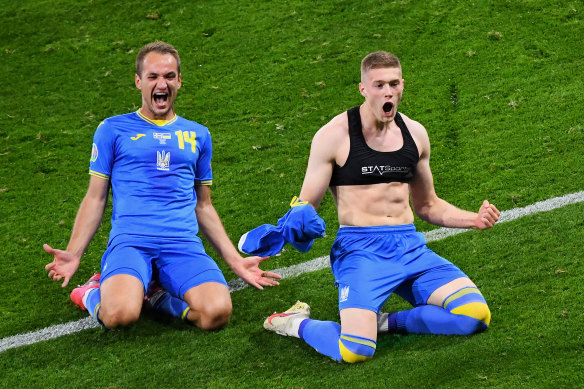 Artem Dovbyk (right) celebrates his late winner for Ukraine.