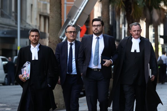 Bruce Lehrmann and his legal team outside the Federal Court in Sydney on Monday.