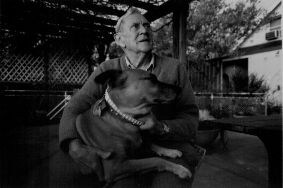 Patrick White at his Cenntenial Park home with his dog Eureka in 1984.