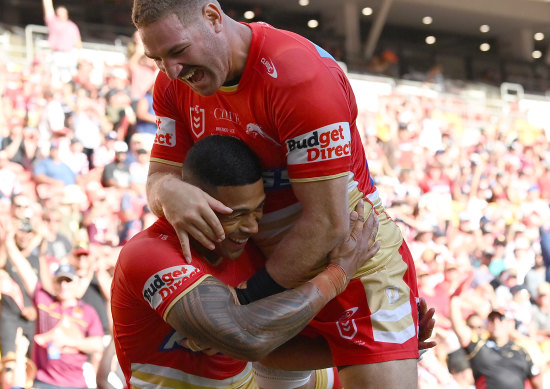 Brenk Lee celebrates with Dolphins teammate Jamayne Isaako after a try in their opening game against the Sydney Roosters at Suncorp Stadium.