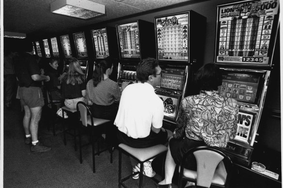 Punters play on poker machines in 1992.