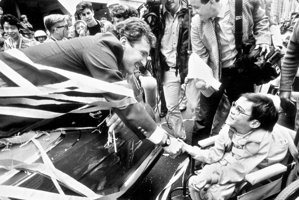 Allan Border greets a fan at the ticker tape parade held in Sydney a few days later.