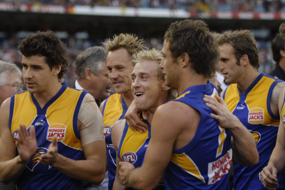 West Coast players jubilant after beating the Crows.