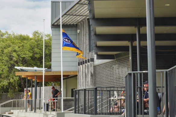 The blue and yellow Beaumaris Football club flies at half-mast. 