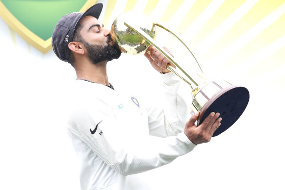 Virat Kohli with the Border-Gavaskar Trophy after their series victory in Australia when they last toured.