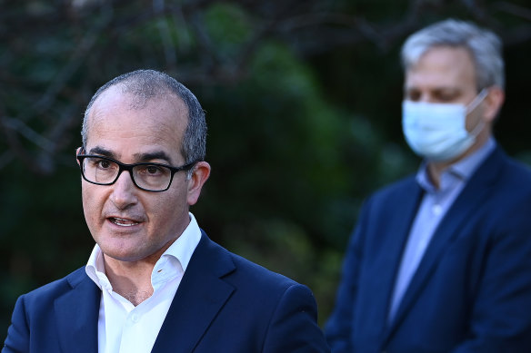 Victoria’s acting Premier, James Merlino, centre, has levelled blame for the state’s latest outbreak on the federal government.