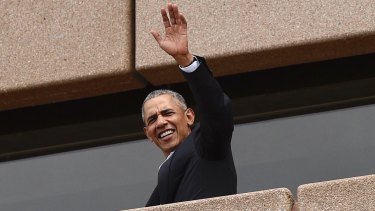 Former US president Barack Obama waves to people at the Sydney Opera House on Friday.