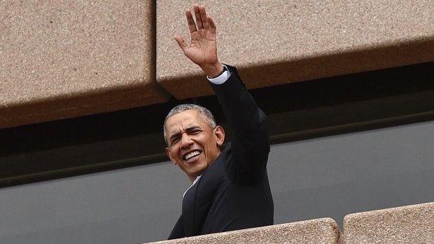 Former US president Barack Obama waves to people at the Sydney Opera House on Friday.