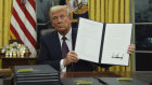 President Trump holds up an executive order commuting sentences for people convicted of offences during the January 6, 2021, riots on Capitol Hill.