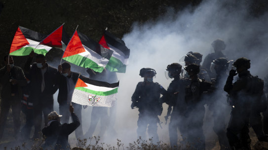 Israeli border police officers clash with Palestinians during a protest against the expansion of Israeli settlements near the West Bank town of Salfit in December 2020. 