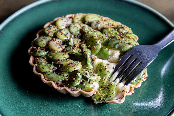 Duck-fat spanner crab tart filled with potato purée, crab mayonnaise and studded with broad beans.