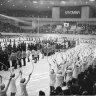 Athletes and officials in the Makomanai indoor skating rink for the closing ceremony of the Sapporo Winter Olympic Games in 1972. The words “Denver, 1976,” can be seen at the electric sign board. 