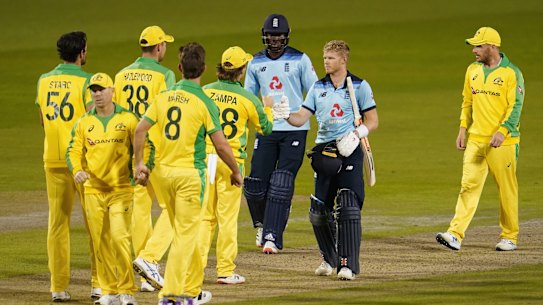 England batsmen Sam Billings, second right, and Jofra Archer, third right, greet Australian players at the end of the first ODI cricket match between England and Australia, at Old Trafford in Manchester, England, Friday, Sept. 11, 2020. (AP Photo/Jon Super, Pool)