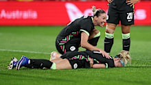 Ellie Carpenter lies down winded after taking a brutal shot to the ribs. 