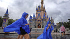 Guests at the Magic Kingdom at Walt Disney World brave wind and rain in Bay Lake, Florida.