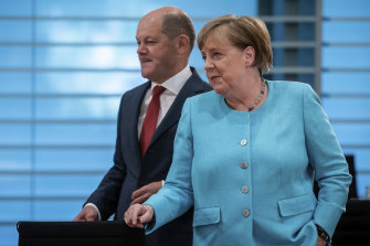 Changing of the guard in Berlin: Olaf Scholz and Angela Merkel.