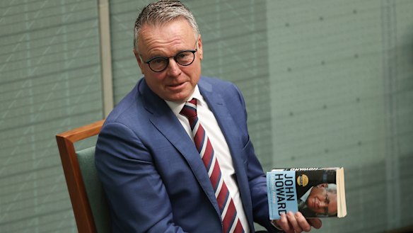 Labor MP Joel Fitzgibbon holds a copy of John Howard’s book ‘Lazarus Rising’ in Question Time.