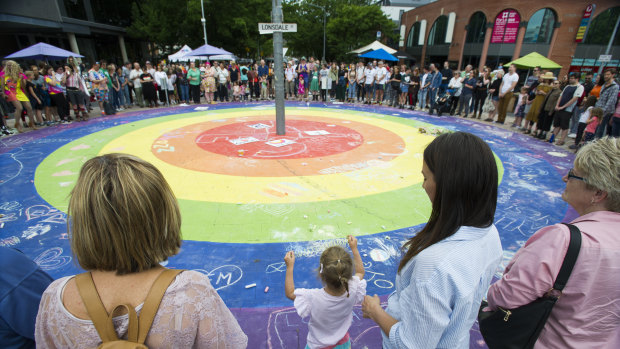 The circle of love at the rainbow roundabout on Lonsdale Street during Saturday's Yes!Fest.