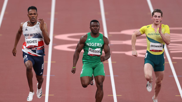 Zharnel Hughes (left) races against Rohan Browning (right) at the Tokyo Olympics.