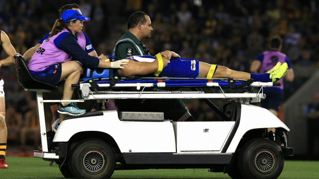 Knock-out blow: North Melbourne's Shaun Higgins  is stretchered off the ground.