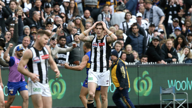 Sinking feeling: Magpies Taylor Adams and Mason Cox react after Luke Sheed kicks the winning goal for West Coast in the Grand Final.