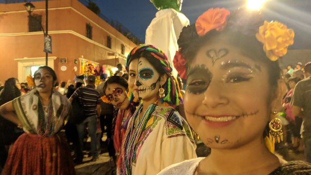 Girls take part in the traditional dances in the streets of Oaxaca during Day of the Dead parade.