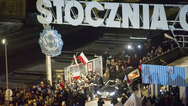 A black hearse with the coffin of  Pawel Adamowicz is  brought to St Mary's Basilica  in Gdansk  for  burial on Saturday.