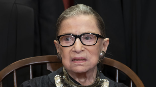 Ruth Bader Ginsburg sits with fellow Supreme Court justices for a group portrait at the Supreme Court Building in Washington. 