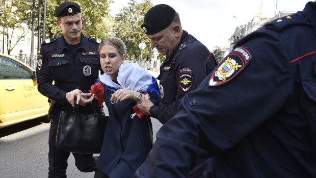Police detain Lyubov Sobol prior to an unsanctioned rally in Moscow in July.