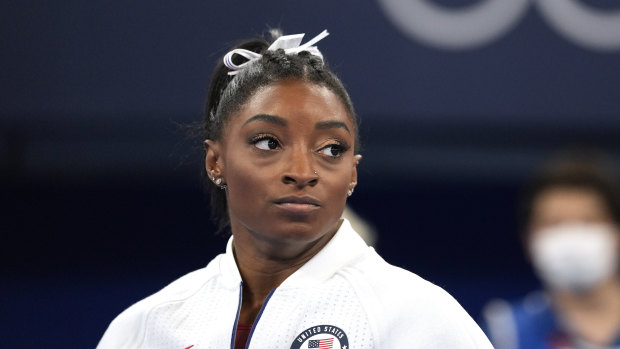 Simone Biles watches on after her shock exit from the team final.