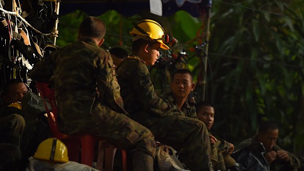 Thai army soldiers rest at the base camp before going to Tham Luang cave.