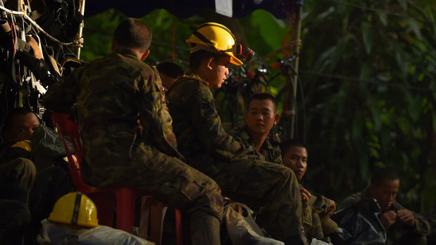 Thai army soldiers rest at the base camp before going to Tham Luang cave.