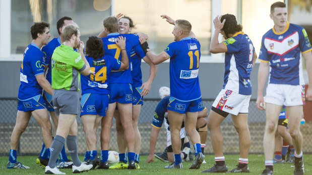Warriors players celebrate a try against the Bushrangers.