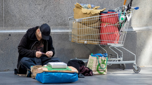 In early May, in the midst of COVID-19, a homeless man sits in George Street, Sydney. 