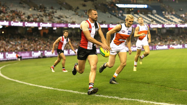 Boundary rider: Jarryn Geary is chased by Nick Haynes at Etihad Stadium.
